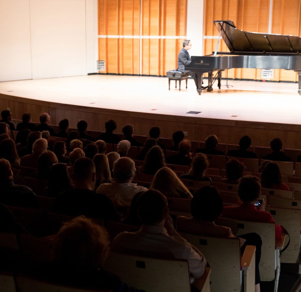 joel performs on stage in front of audience